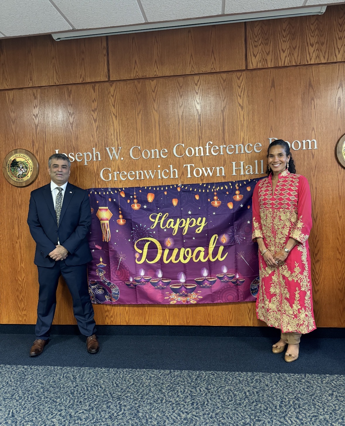 Rajeev Pahuja beside a Happy Diwali banner at Greenwich Town Hall